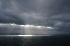 Sun shining through clouds on Atlantic Ocean
